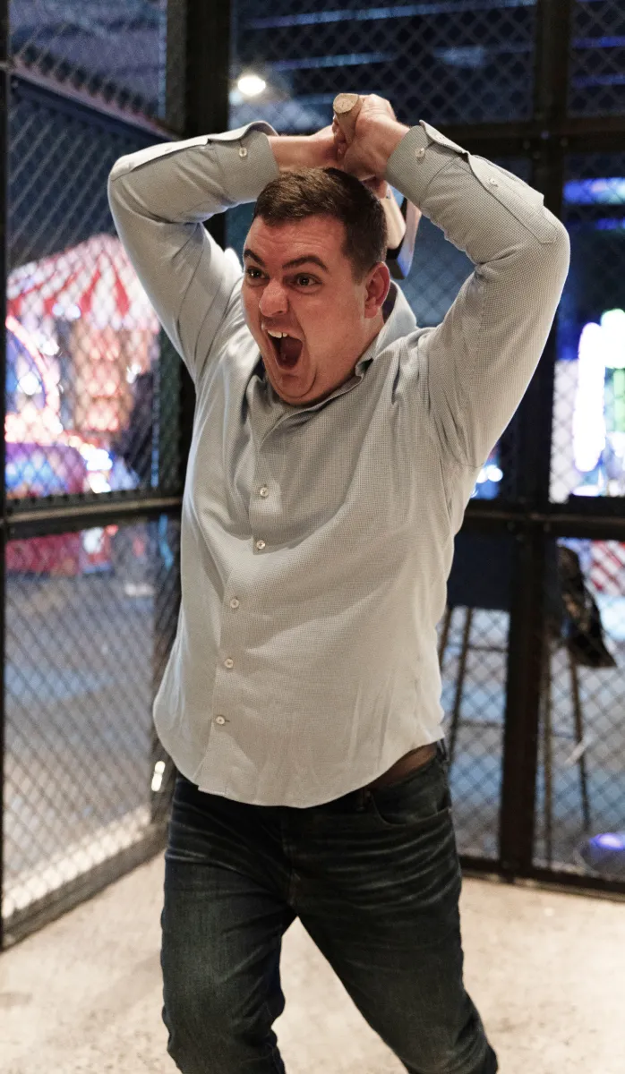 a man throwing an axe in an arcade