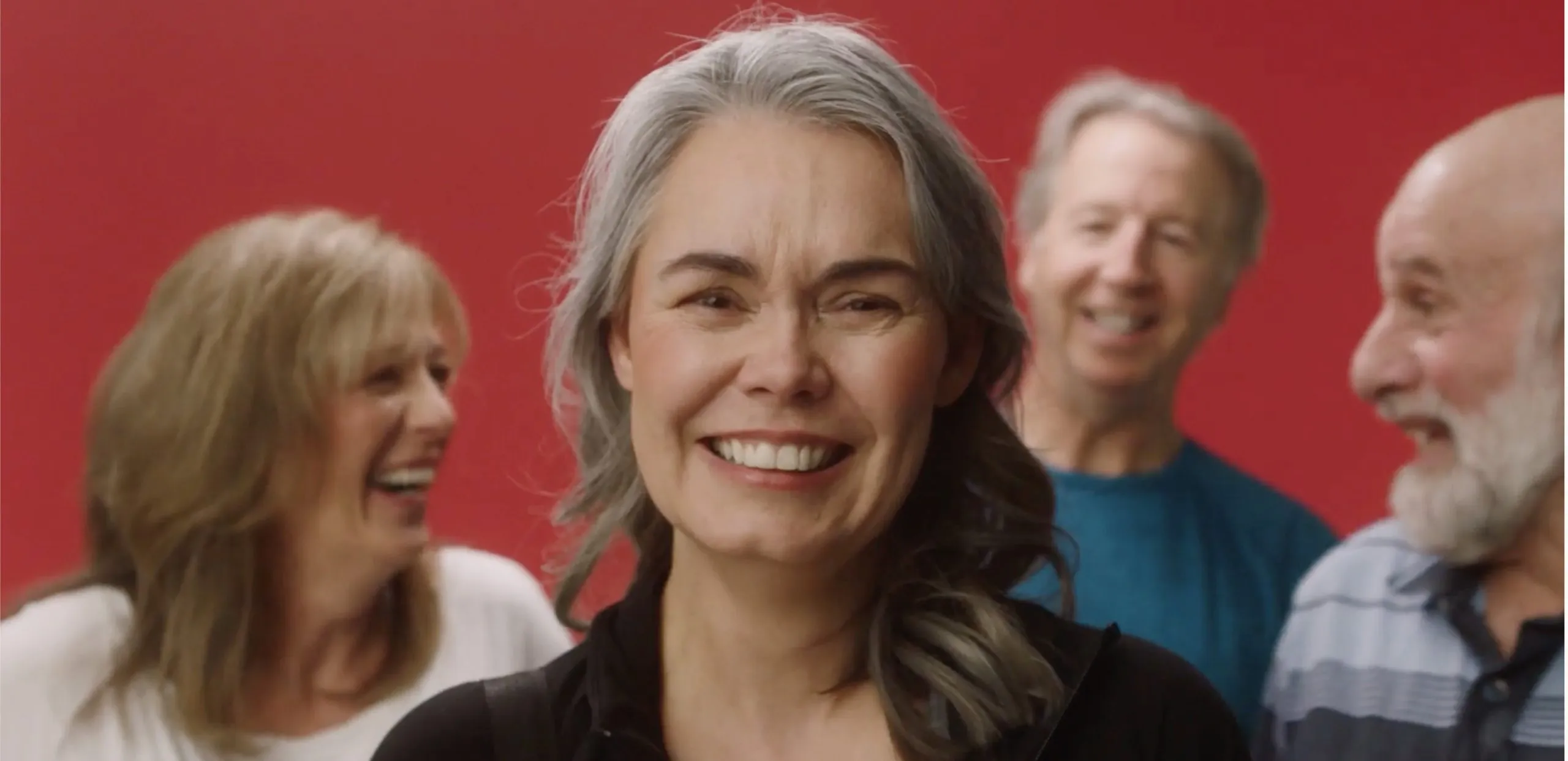 older men and woman laughing and smiling