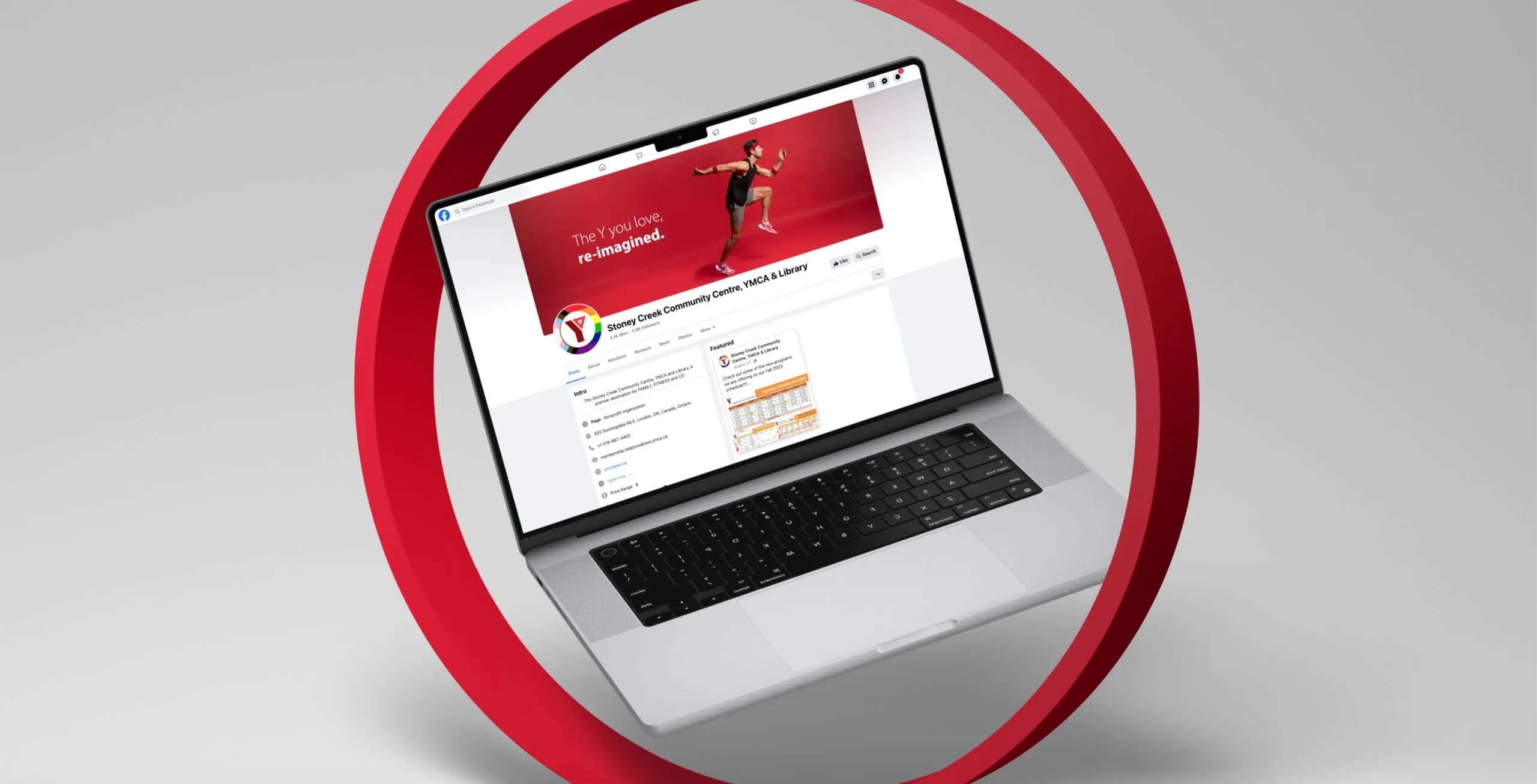 a laptop displaying the YMCA facebook page